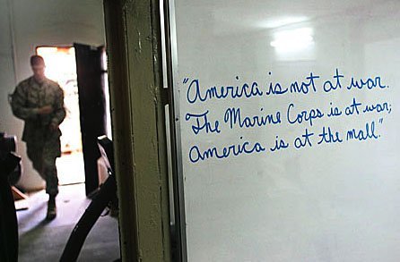 White board that says: "America is not at war. The Marine Corps is at war. America is at the mall"