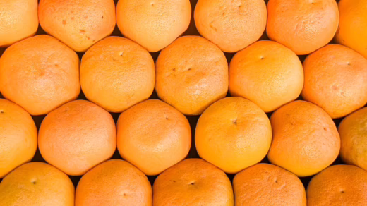 fresh oranges in a neat pattern display