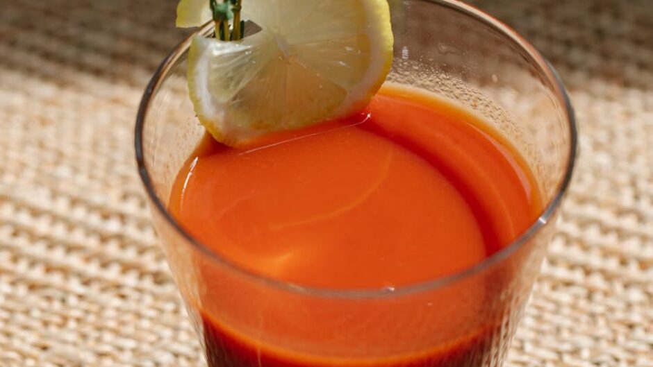 glass of bloody mary cocktail in sunlight