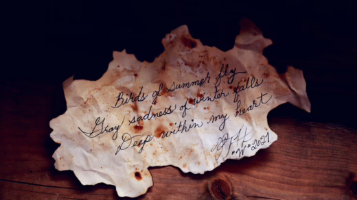 white burnt paper with text on brown wooden table