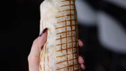 hand holding burrito