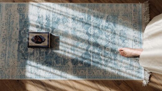 top view of a prayer carpet and barefoot woman