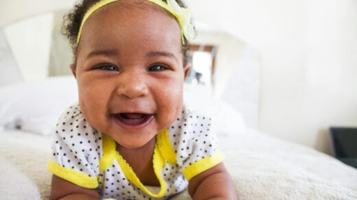 baby wearing white and yellow shirt