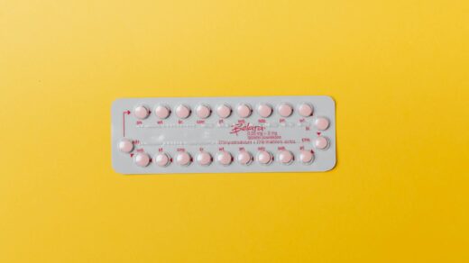 pink pills on yellow surface