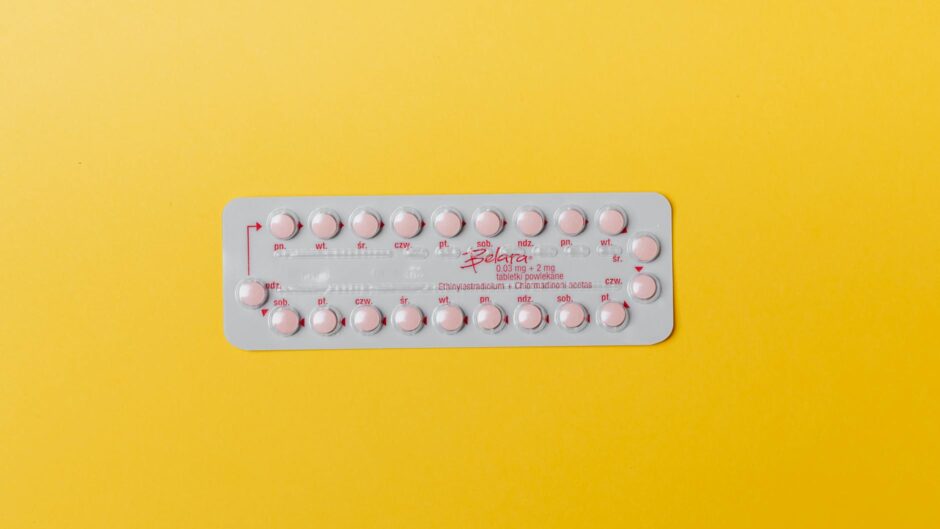 pink pills on yellow surface