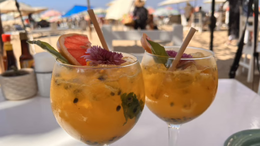 two fruity cocktail glasses on a table on a sunny day. drinks, holiday, fun, good vibes, vacation, weekend, glasses