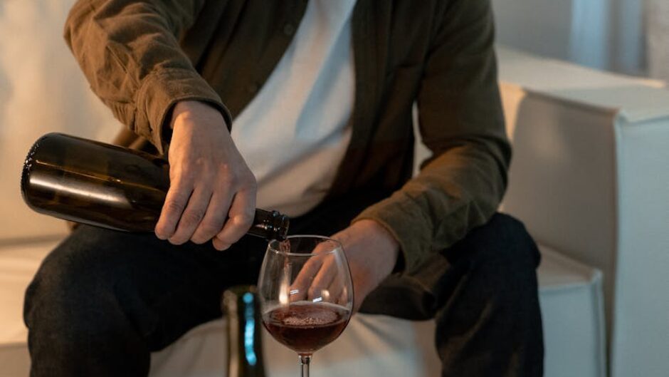 a man drinking wine at home
