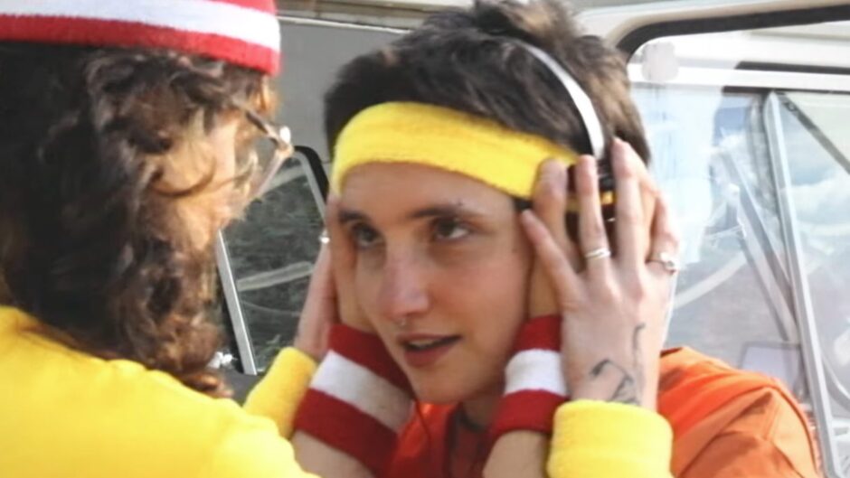 screenshot of the video for Francis of Delirium's song It's A Beautiful Life. It's a woman in headphones with somebody else holding them.